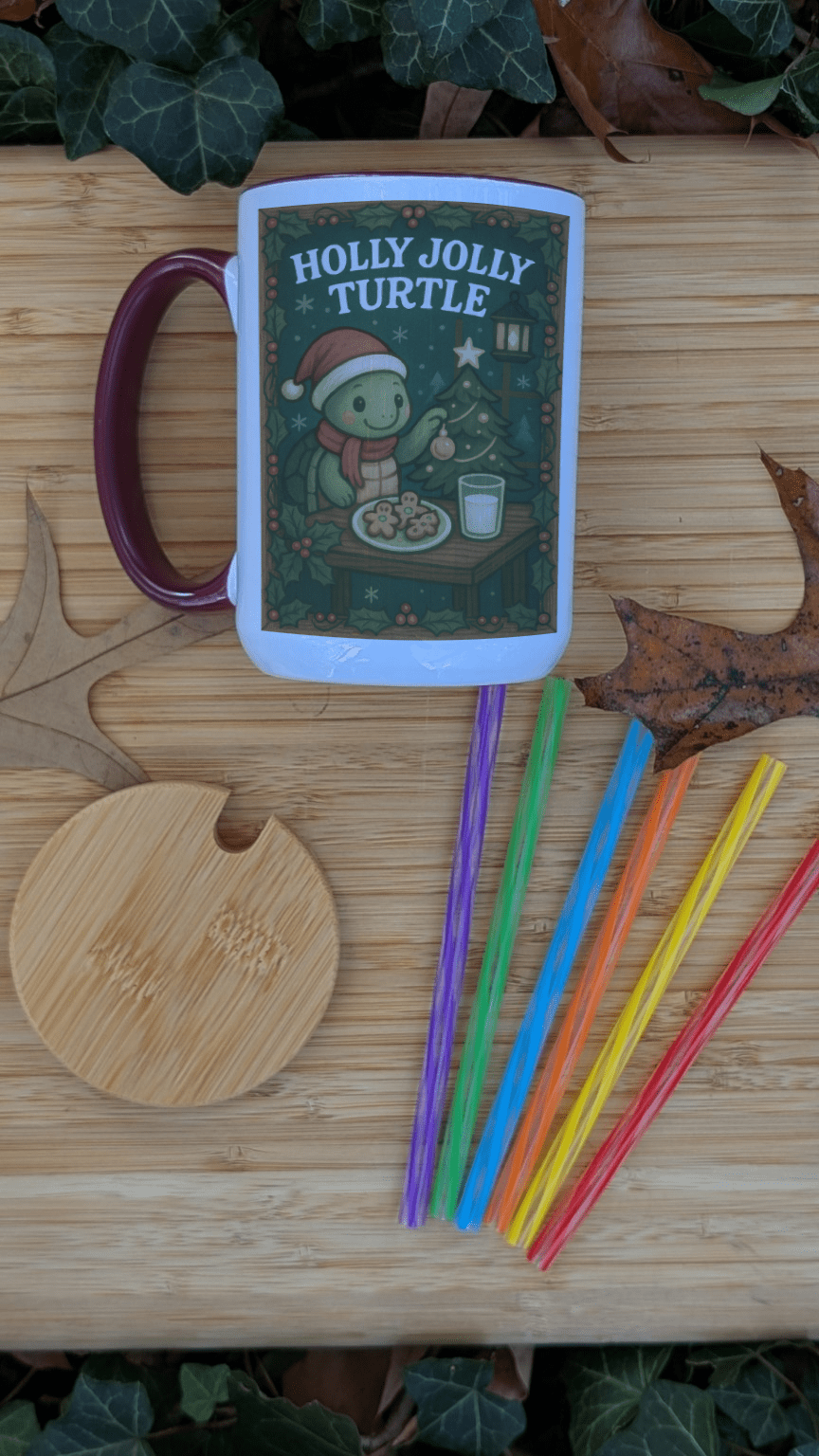 Mug with 'Holly Jolly Turtle' design on a wooden surface with colorful straws.